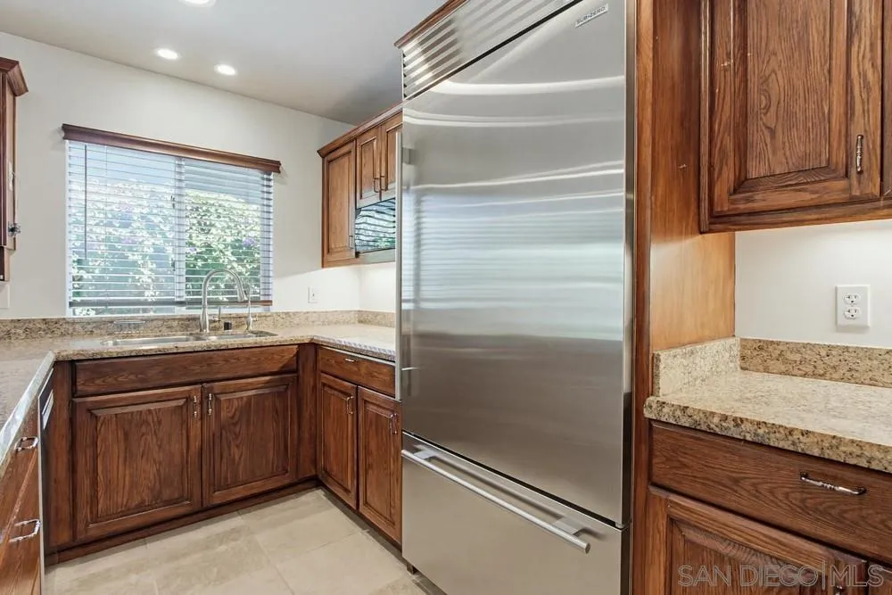 545 Bonair Way La Jolla, CA 92037 - Photo 11 of 57 a kitchen with a refrigerator and two sink