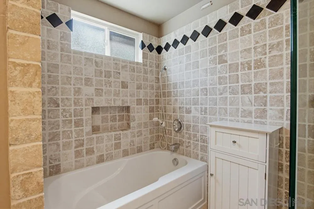 545 Bonair Way La Jolla, CA 92037 - Photo 14 of 57 a bathroom with a bathtub and shower