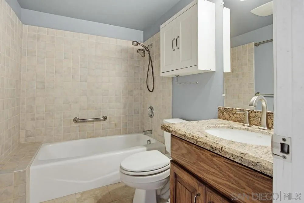 545 Bonair Way La Jolla, CA 92037 - Photo 15 of 57 a bathroom with a granite countertop sink a toilet and bathtub