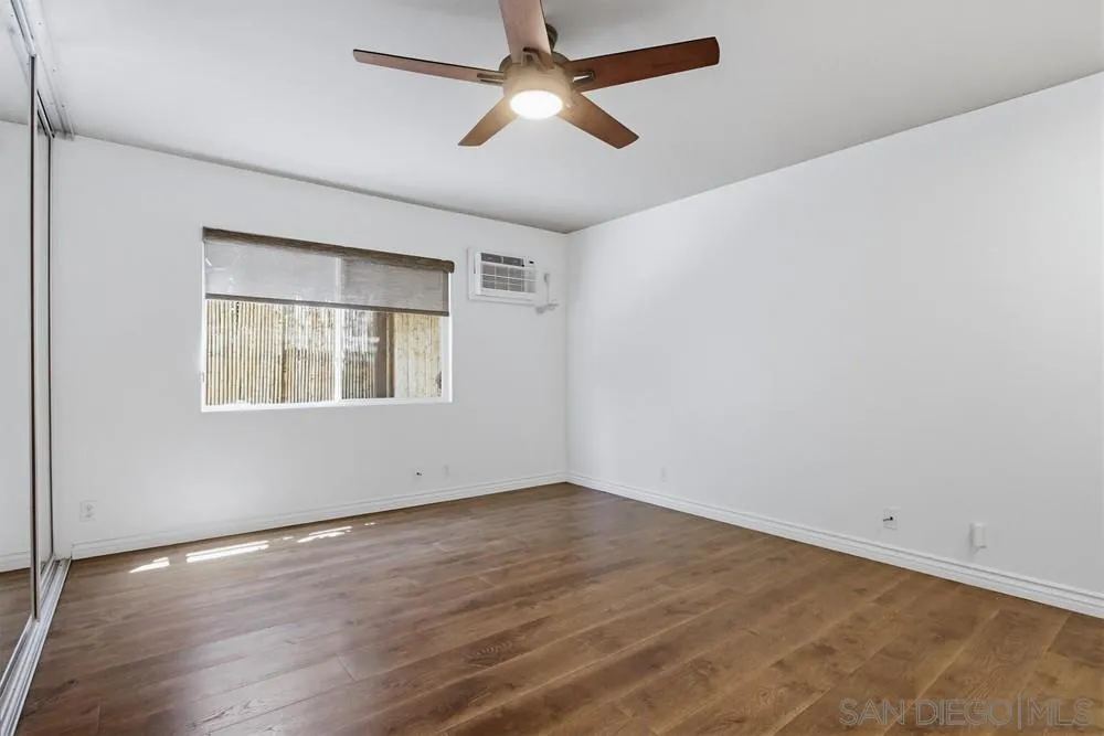 545 Bonair Way La Jolla, CA 92037 - Photo 18 of 57 a view of an empty room with window and wooden floor