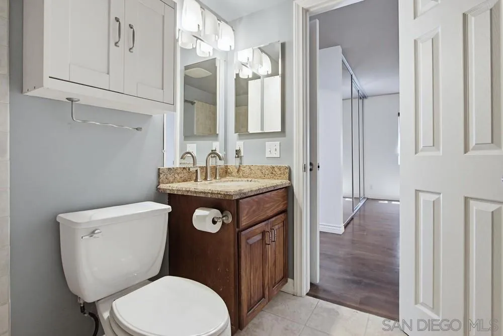 545 Bonair Way La Jolla, CA 92037 - Photo 20 of 57 a bathroom with a toilet sink and mirror