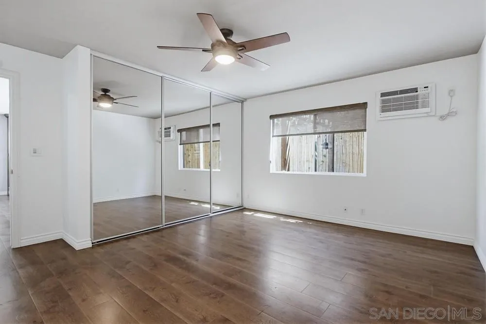 545 Bonair Way La Jolla, CA 92037 - Photo 21 of 57 an empty room with wooden floor and windows