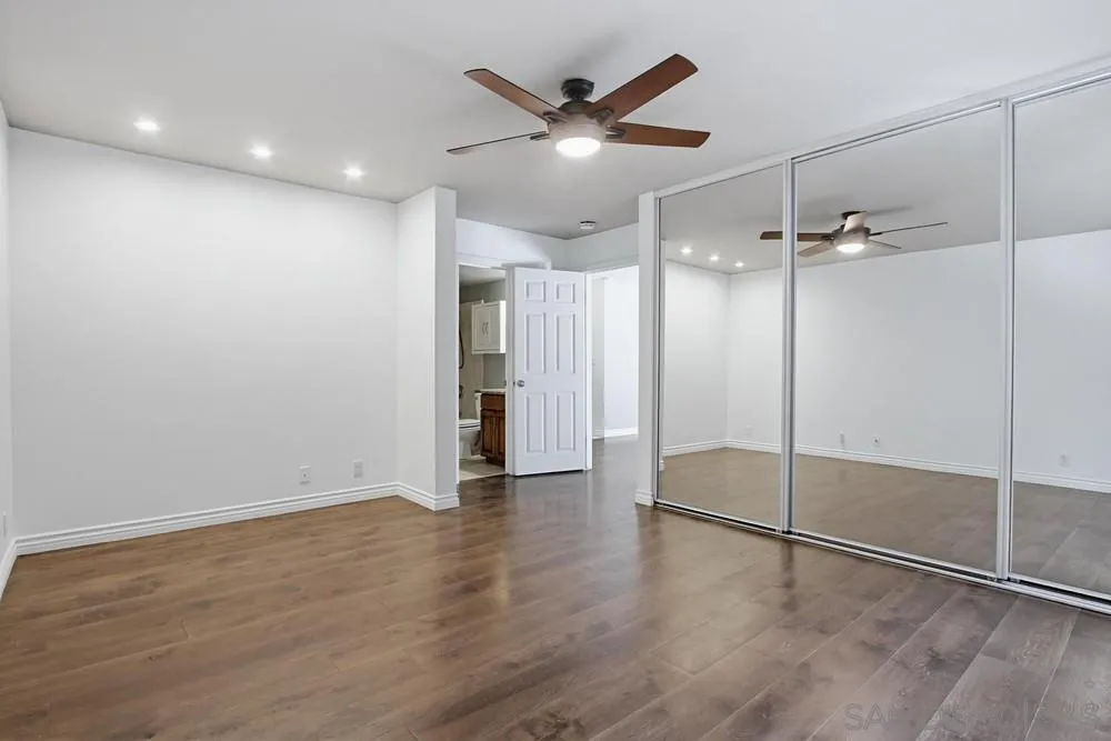 545 Bonair Way La Jolla, CA 92037 - Photo 22 of 57 wooden floor in an empty room with a ceiling fan