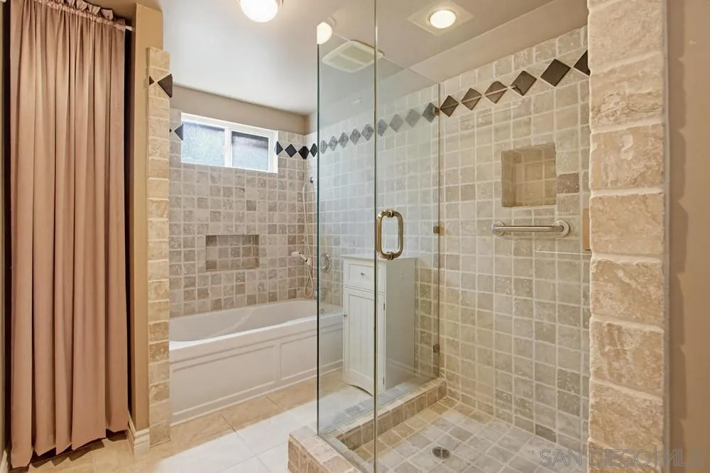 545 Bonair Way La Jolla, CA 92037 - Photo 23 of 57 a bathroom with a shower and a bathtub