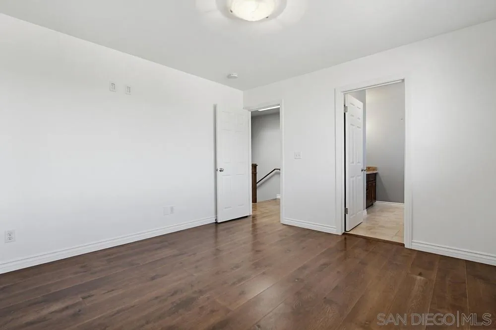 545 Bonair Way La Jolla, CA 92037 - Photo 24 of 57 a view of an empty room with wooden floor and a window