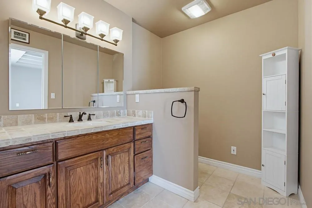 545 Bonair Way La Jolla, CA 92037 - Photo 28 of 57 a bathroom with a sink and a mirror
