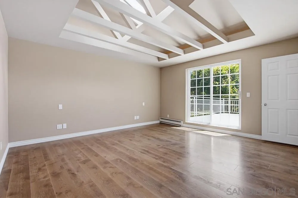 545 Bonair Way La Jolla, CA 92037 - Photo 29 of 57 an empty room with wooden floor and windows