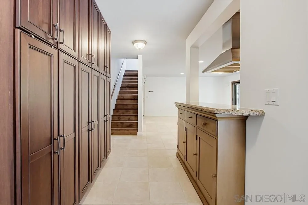545 Bonair Way La Jolla, CA 92037 - Photo 31 of 57 a kitchen with stainless steel appliances granite countertop a sink and a refrigerator