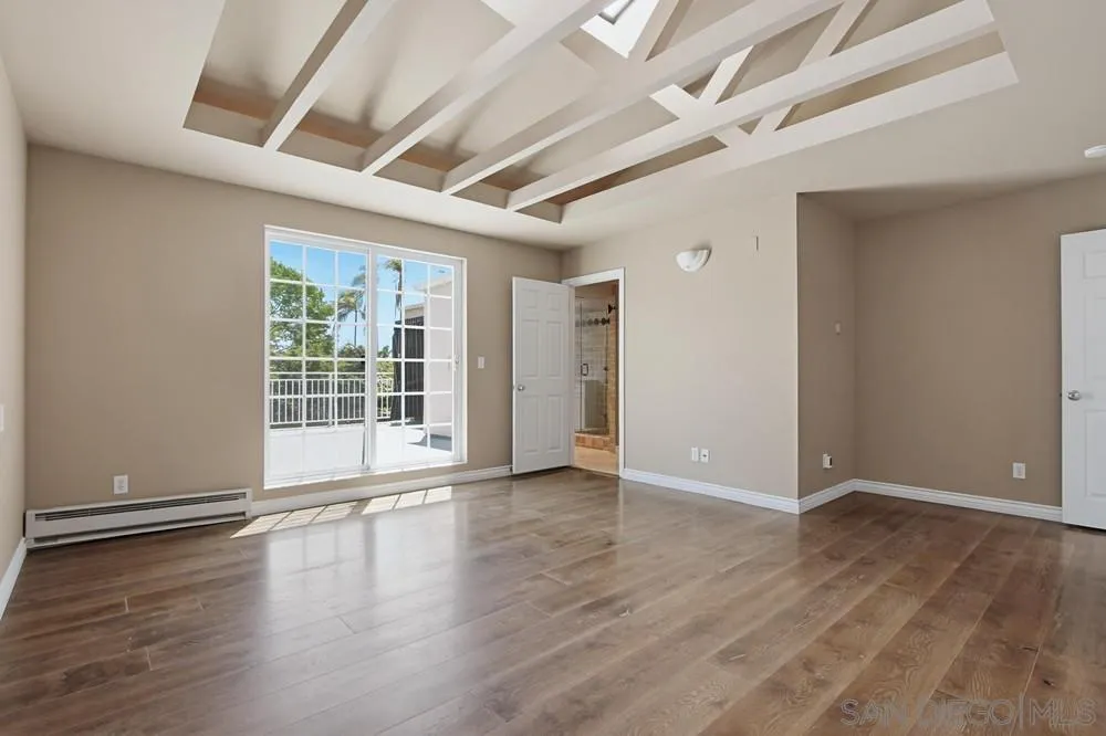 545 Bonair Way La Jolla, CA 92037 - Photo 32 of 57 an empty room with wooden floor and windows