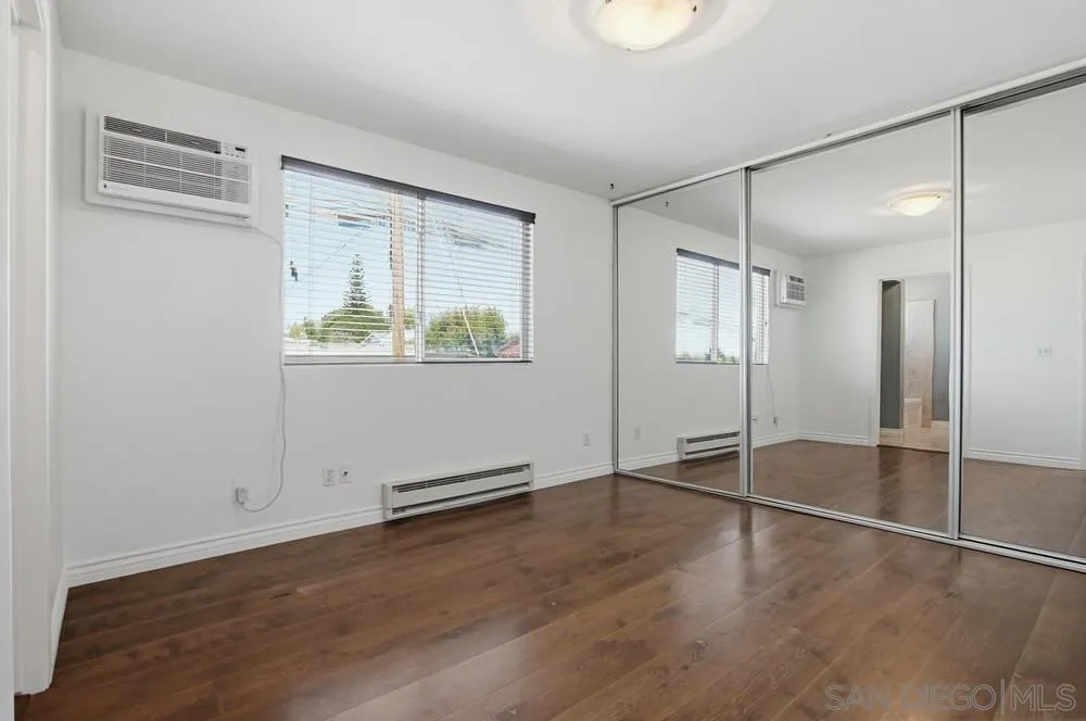 545 Bonair Way La Jolla, CA 92037 - Photo 35 of 57 an empty room with wooden floor and window