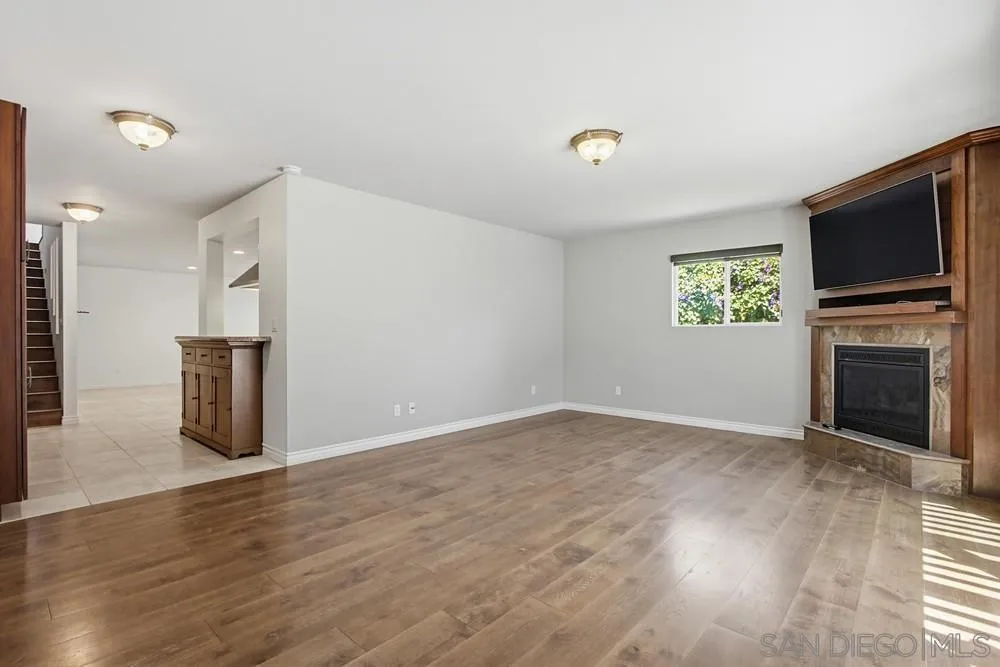 545 Bonair Way La Jolla, CA 92037 - Photo 40 of 57 a view of empty room with wooden floor and fireplace