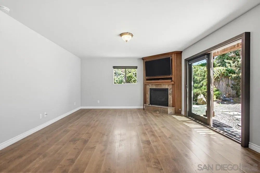 545 Bonair Way La Jolla, CA 92037 - Photo 4 of 57 a view of empty room with wooden floor and fireplace
