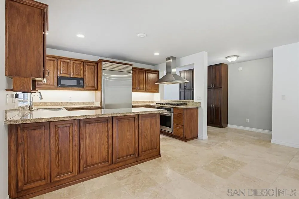 545 Bonair Way La Jolla, CA 92037 - Photo 7 of 57 a kitchen with stainless steel appliances a refrigerator and a sink