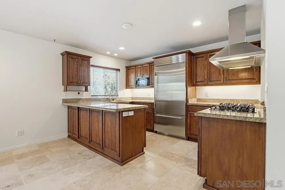 545 Bonair Way La Jolla, CA 92037 - Photo 8 of 57 a kitchen with stainless steel appliances granite countertop a refrigerator and a stove top oven