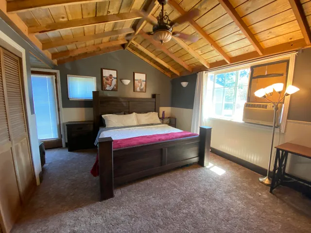 a bed room with a bed and a window