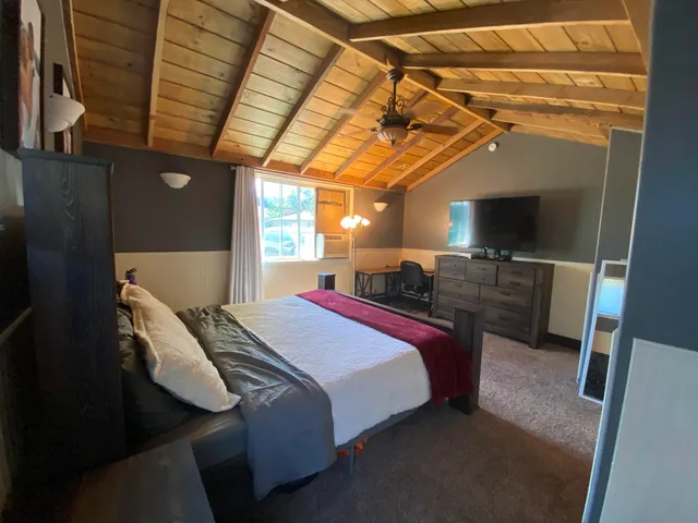 a bed sitting in a bedroom next to a window