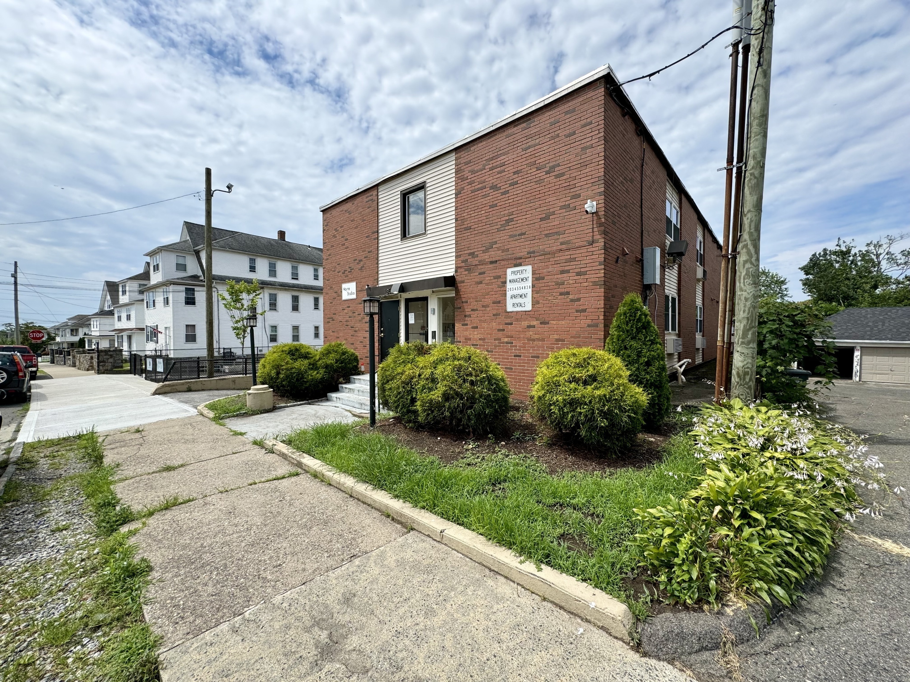 155 Wayne Street, Unit 3 Bridgeport, CT 06606 - Photo 1 of 1 a front view of a house with a yard and potted plants
