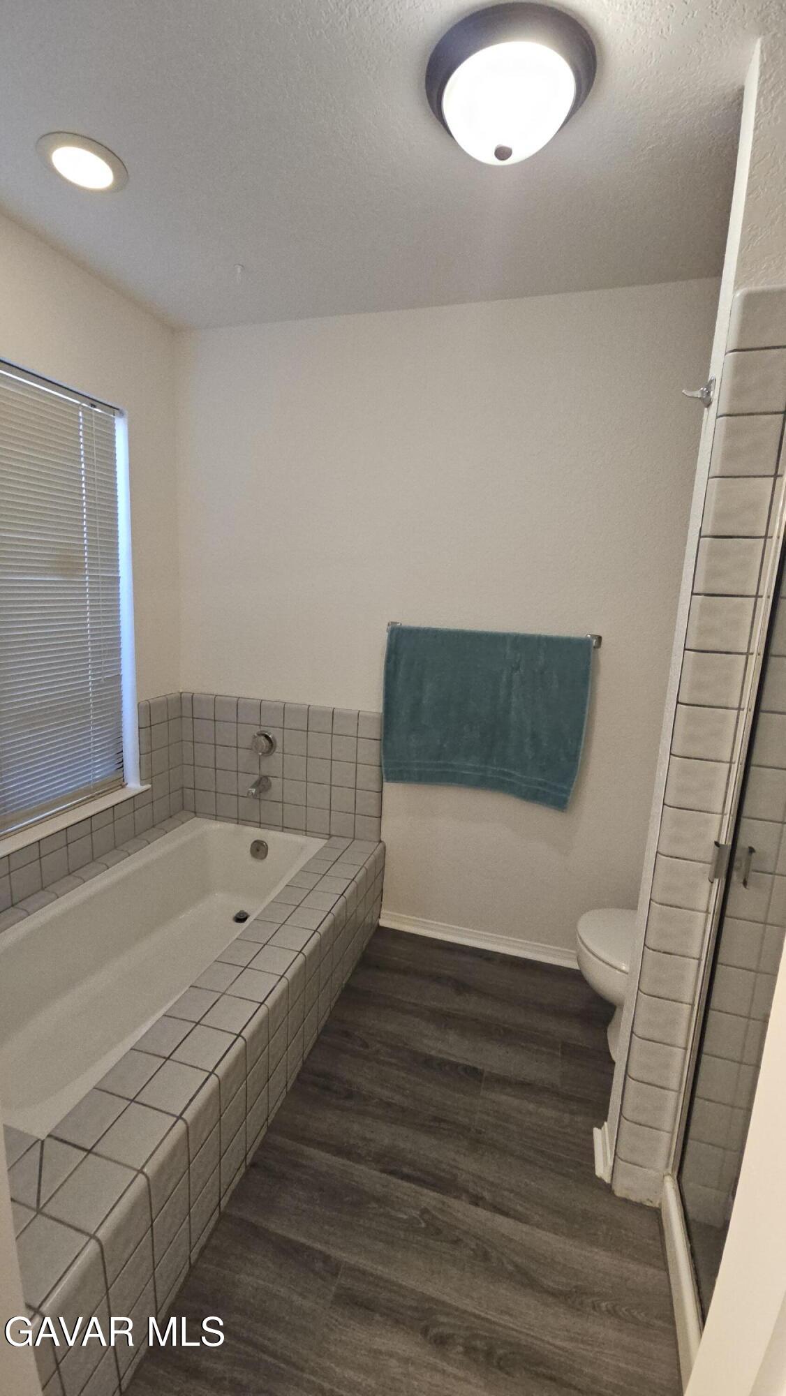 39005 161st Street East Palmdale, CA 93591 - Photo 19 of 27 a bathroom with a tub a sink and a toilet