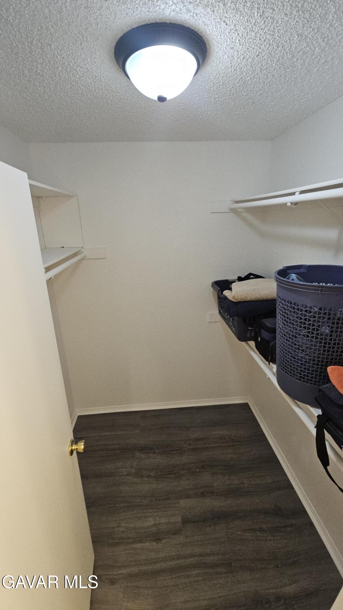 39005 161st Street East Palmdale, CA 93591 - Photo 21 of 27 a view of walk in closet with clothes and shoes