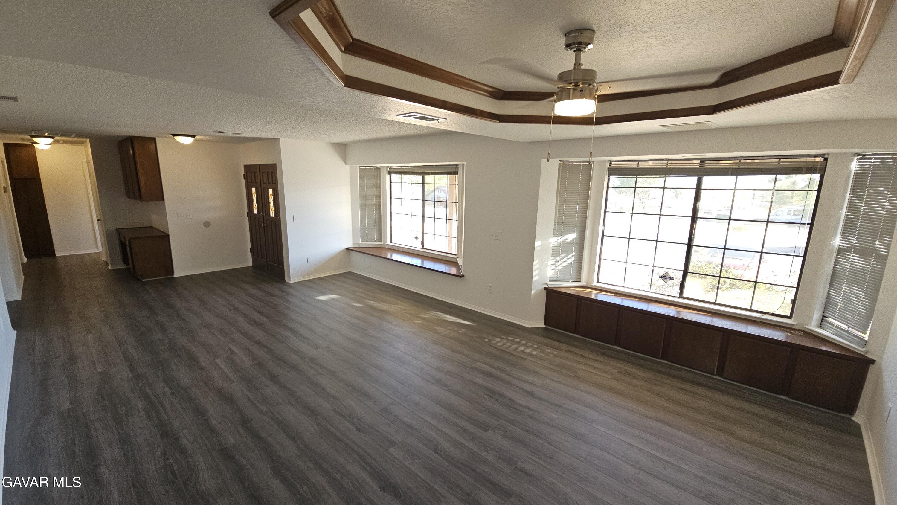 39005 161st Street East Palmdale, CA 93591 - Photo 3 of 27 a view of an empty room with wooden floor and a window