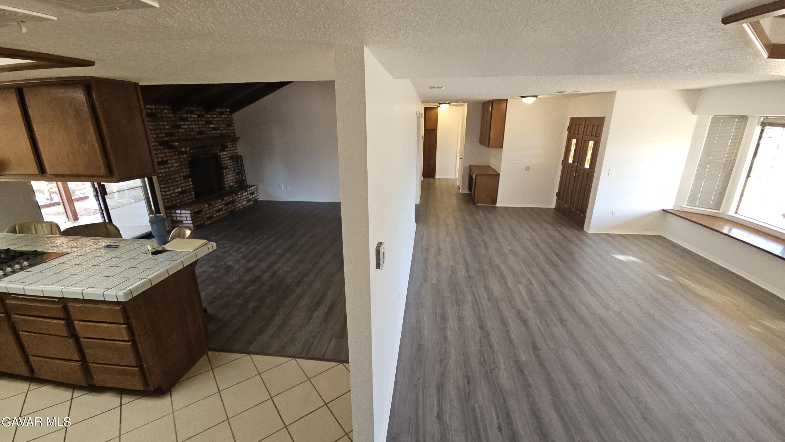 39005 161st Street East Palmdale, CA 93591 - Photo 5 of 27 a hallway view with fireplace and wooden floor