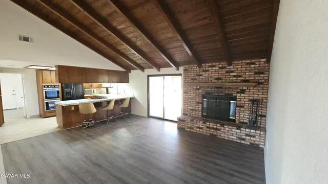 a living room with furniture wooden floor and a fireplace