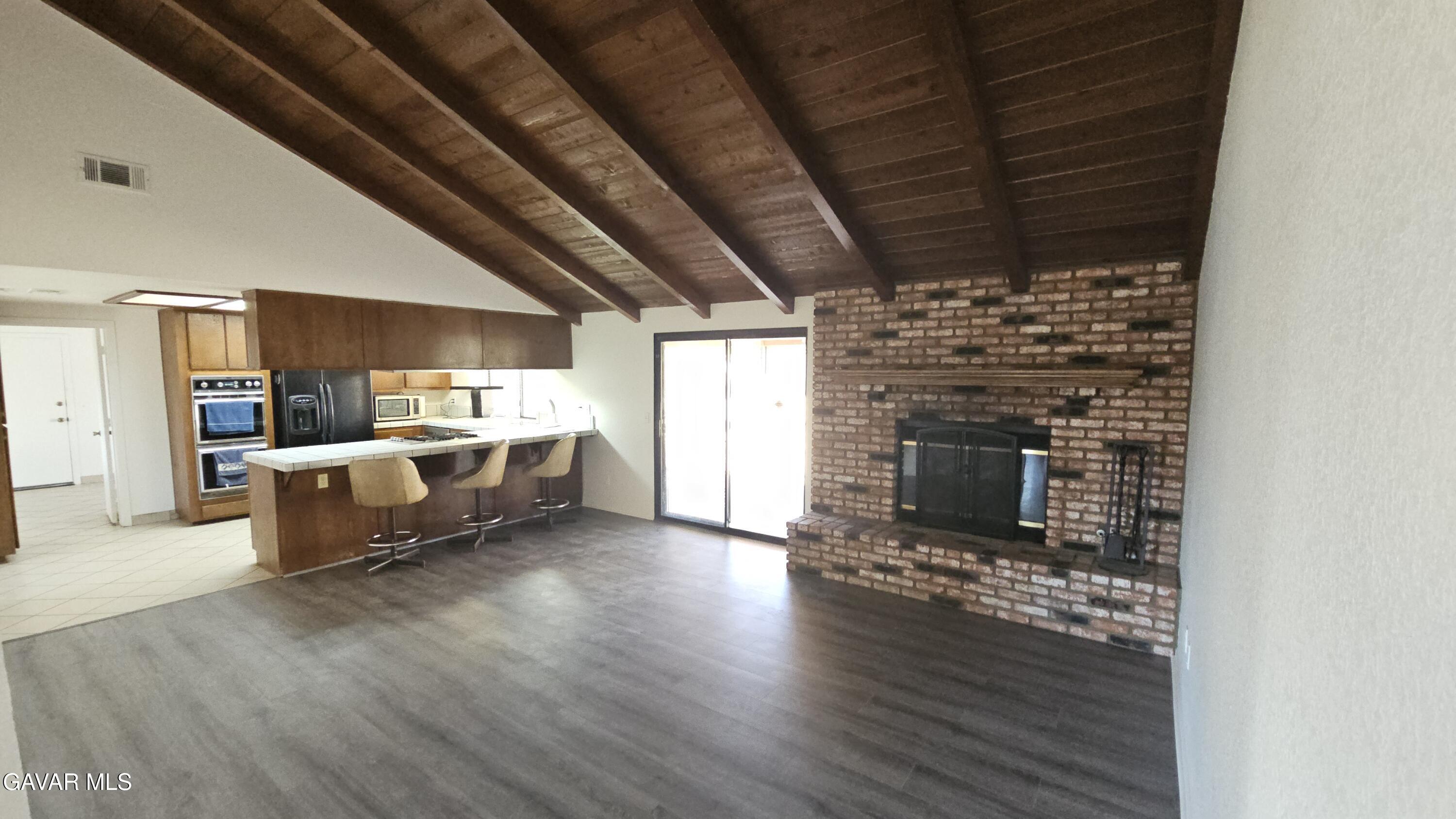 39005 161st Street East Palmdale, CA 93591 - Photo 8 of 27 a living room with furniture wooden floor and a fireplace