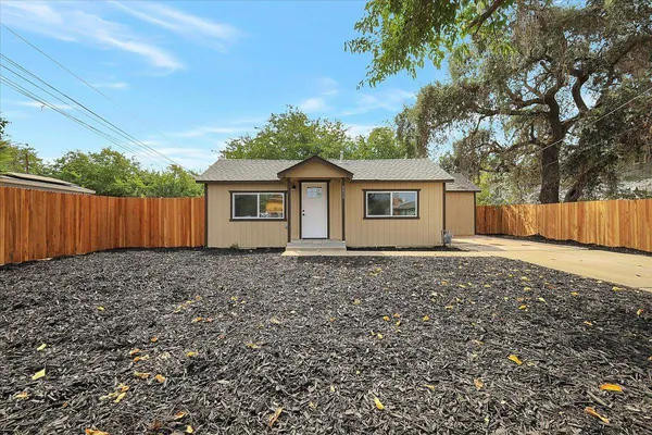 a house with a tree in front of it