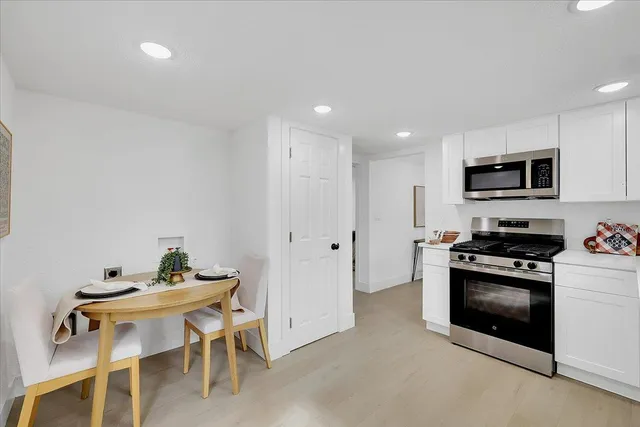 a kitchen with a sink cabinets and stainless steel appliances