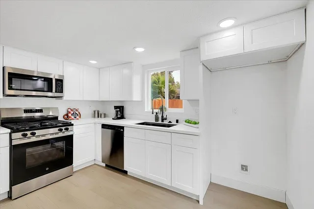 a kitchen with a sink stove and microwave