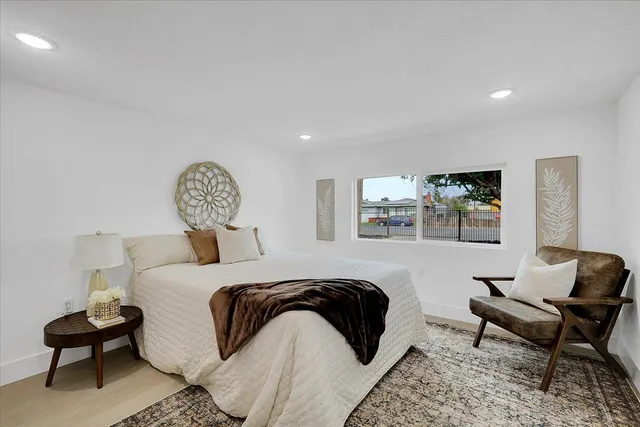 a bedroom with a bed and a chair