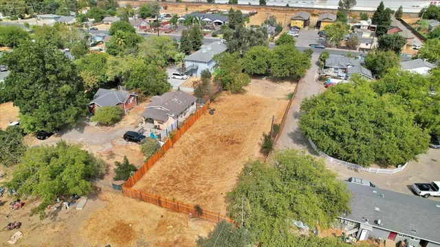 an aerial view of a house with a yard and trees