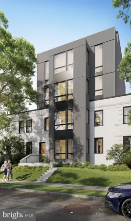 a front view of a residential apartment building with a yard
