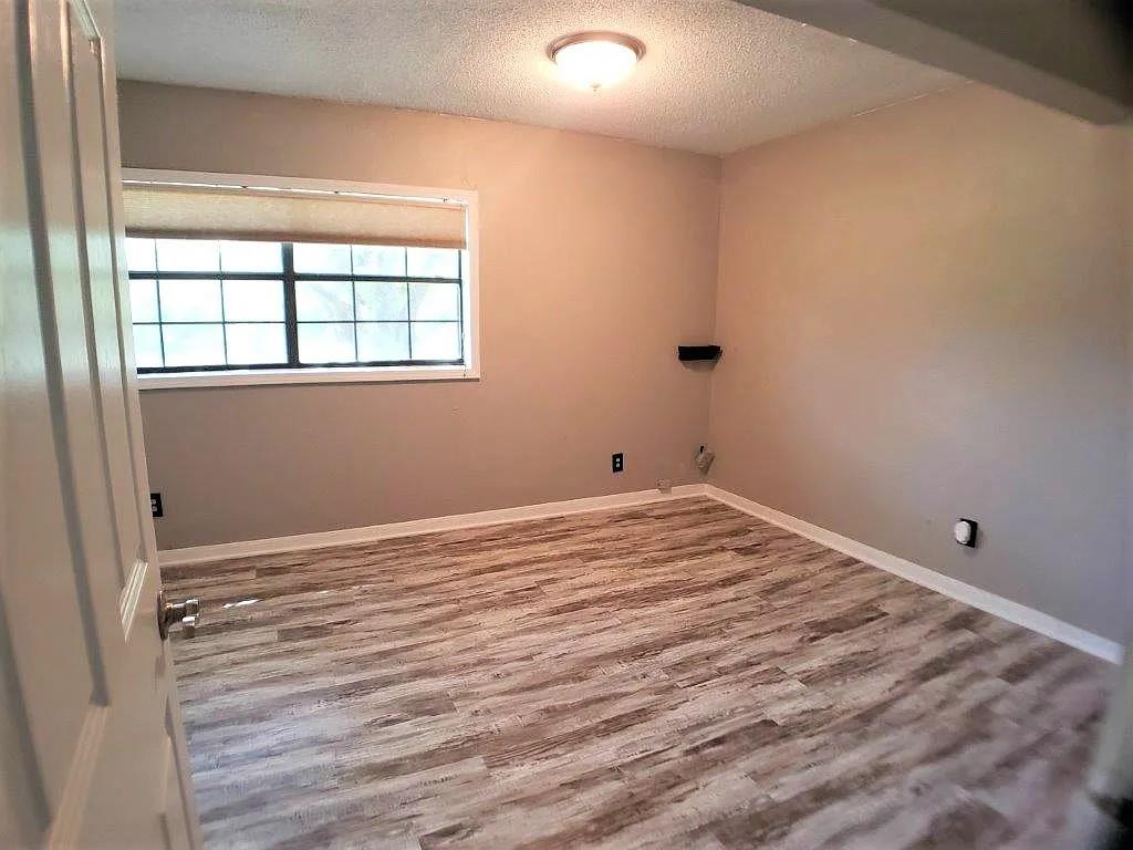 1168 Preston Meadows Road Sherman, TX 75092 - Photo 17 of 20 a view of empty room with wooden floor