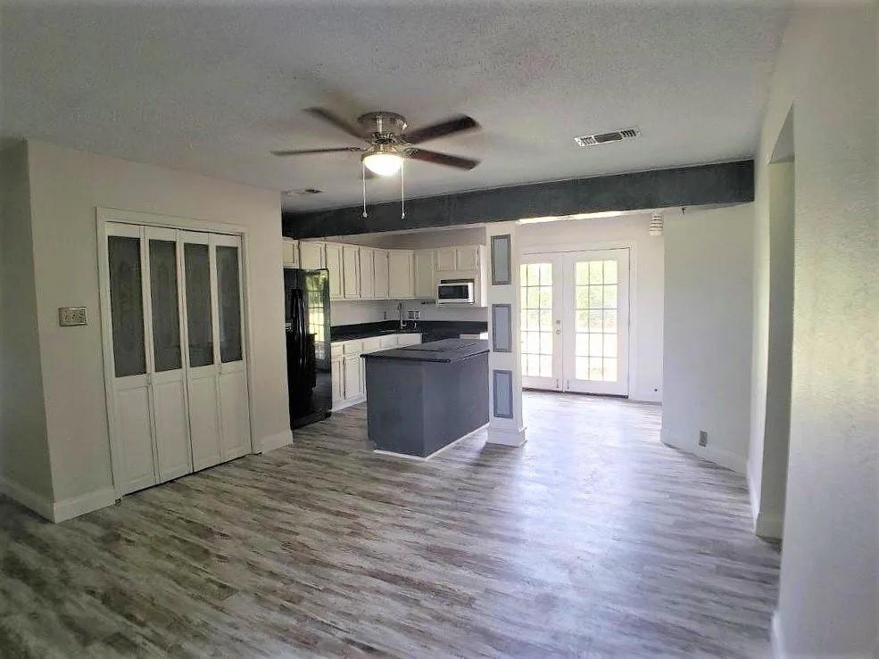 1168 Preston Meadows Road Sherman, TX 75092 - Photo 4 of 20 a large kitchen with stainless steel appliances granite countertop a refrigerator a stove top oven a sink and dishwasher with wooden floor