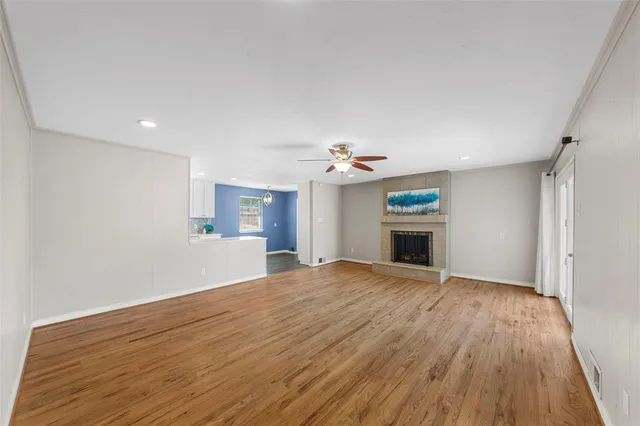 a view of an empty room with a fireplace and a window