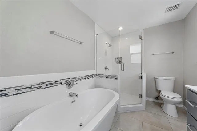 a bathroom with a bathtub and a toilet