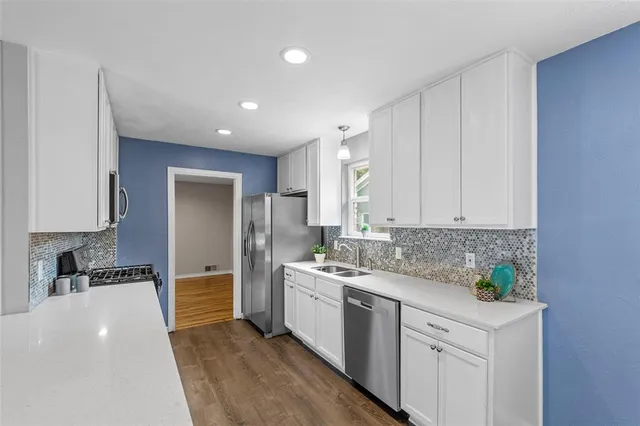 a kitchen with a sink stove and refrigerator
