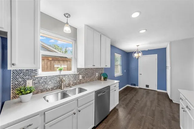 a large white kitchen with a window