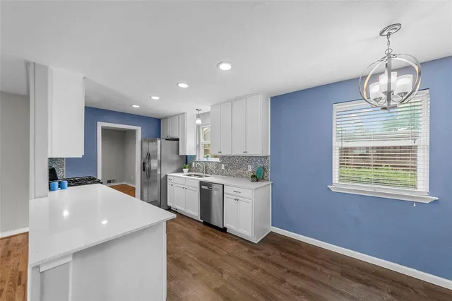a kitchen view with stainless steel appliances granite countertop a sink stove and refrigerator