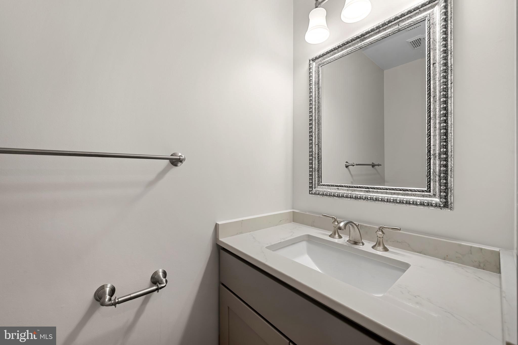 2603 Spartan Road Olney, MD 20832 - Photo 19 of 62 a bathroom with a sink and a mirror