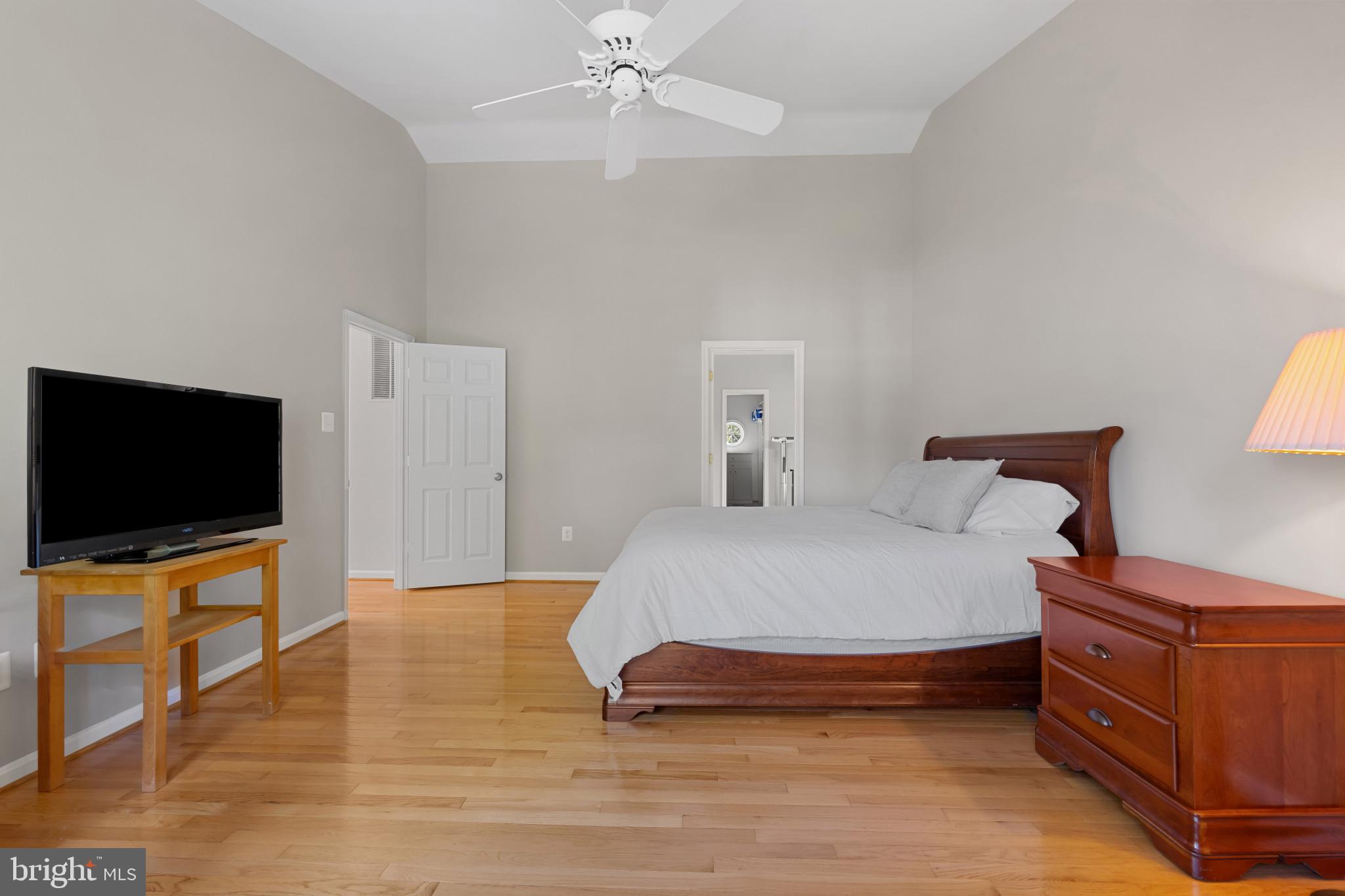2603 Spartan Road Olney, MD 20832 - Photo 22 of 62 a spacious bedroom with a bed and a flat screen tv