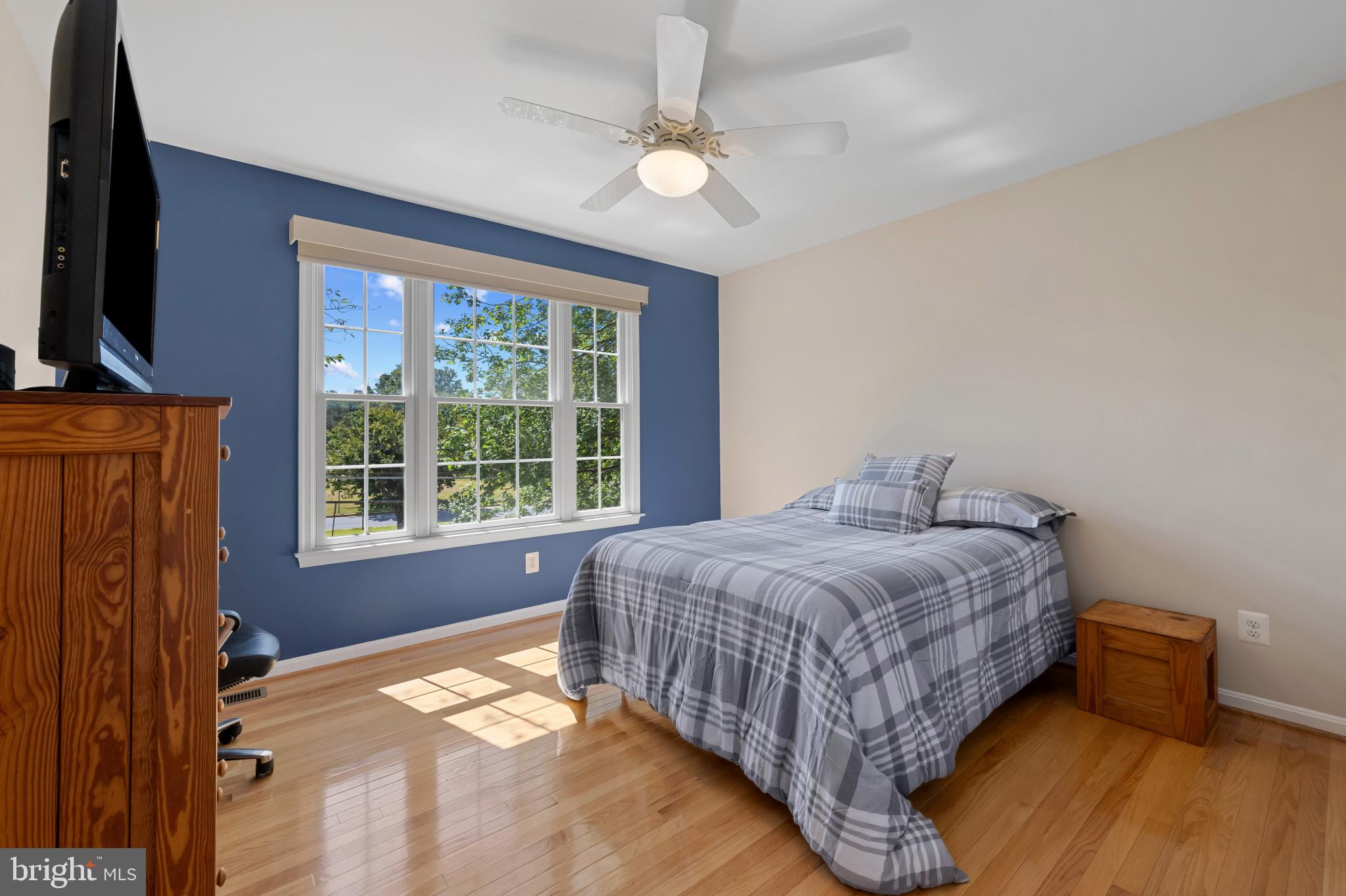 2603 Spartan Road Olney, MD 20832 - Photo 30 of 62 a bedroom with a bed and a flat tv screen on dresser