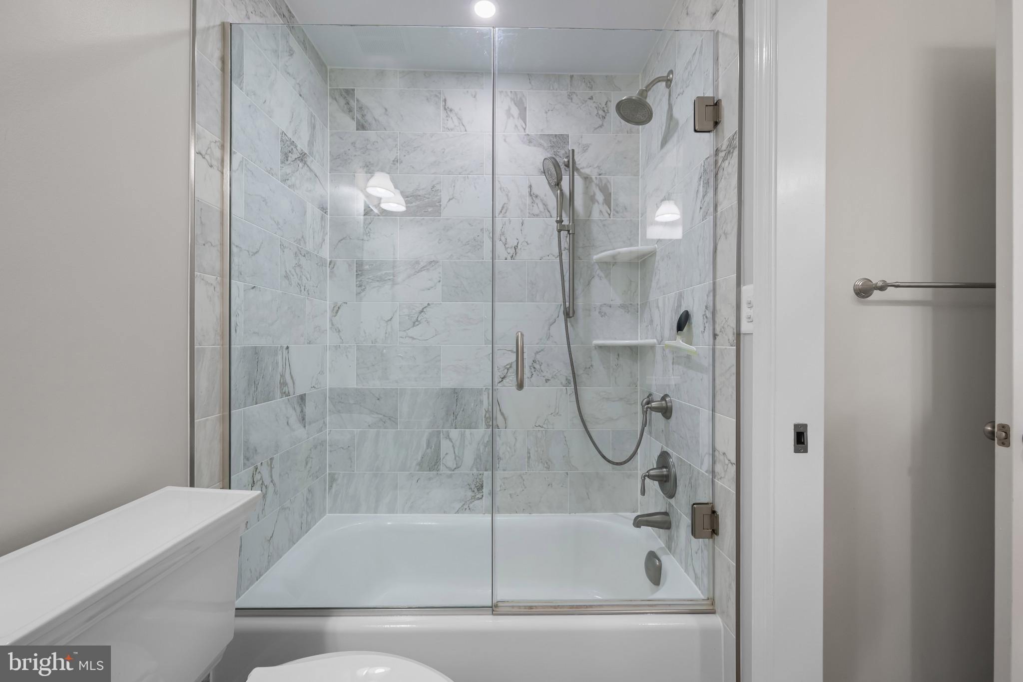 2603 Spartan Road Olney, MD 20832 - Photo 34 of 62 a bathroom with a glass shower door