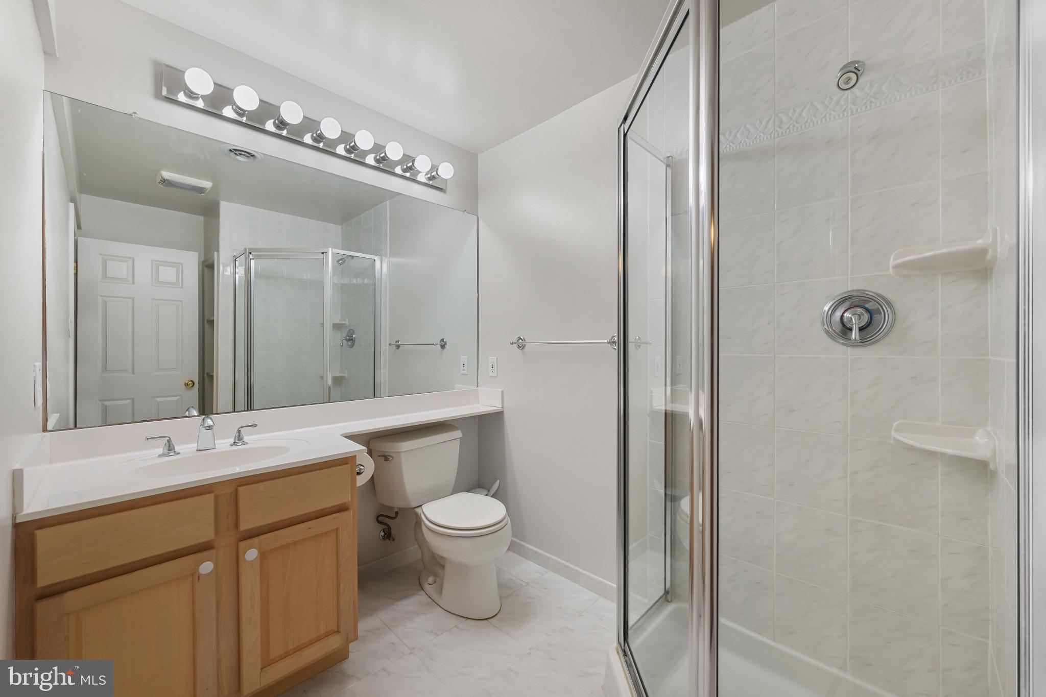 2603 Spartan Road Olney, MD 20832 - Photo 47 of 62 a bathroom with a double vanity sink mirror and toilet