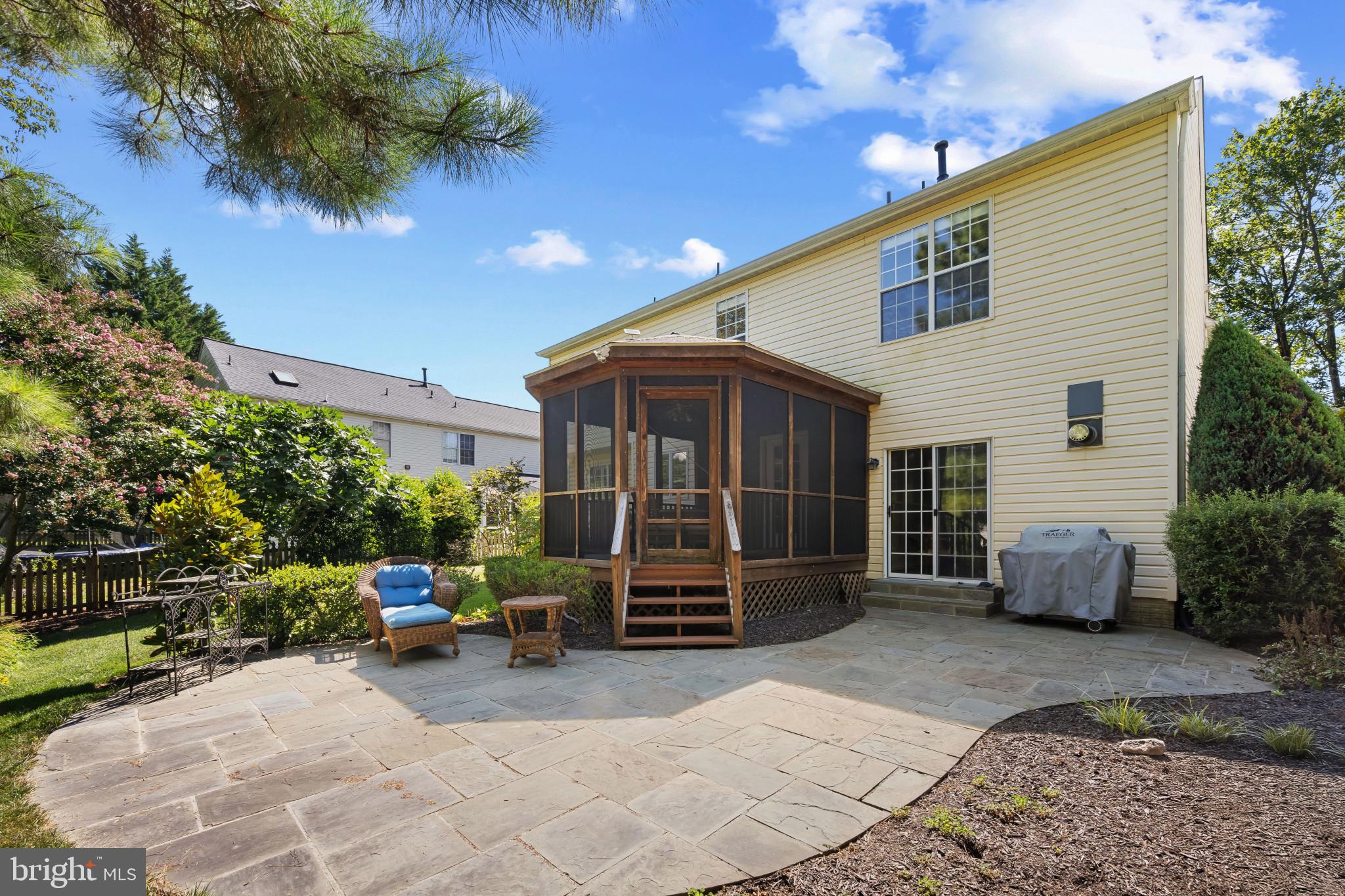 2603 Spartan Road Olney, MD 20832 - Photo 52 of 62 a view of a chair and tables in the back yard of the house