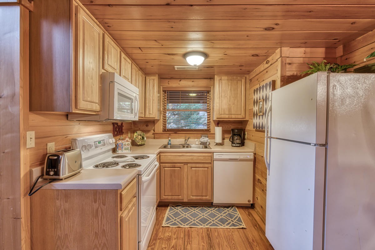 3126 Smoky Ridge Way Sevierville, TN 37862 - Photo 8 of 14 a kitchen with a stove a refrigerator and a sink