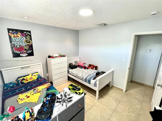 a bedroom with two beds and a couch