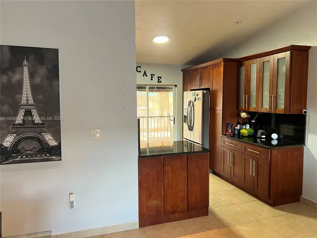 a kitchen with wooden cabinets and a sink