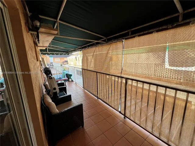 a view of deck with furniture and trees
